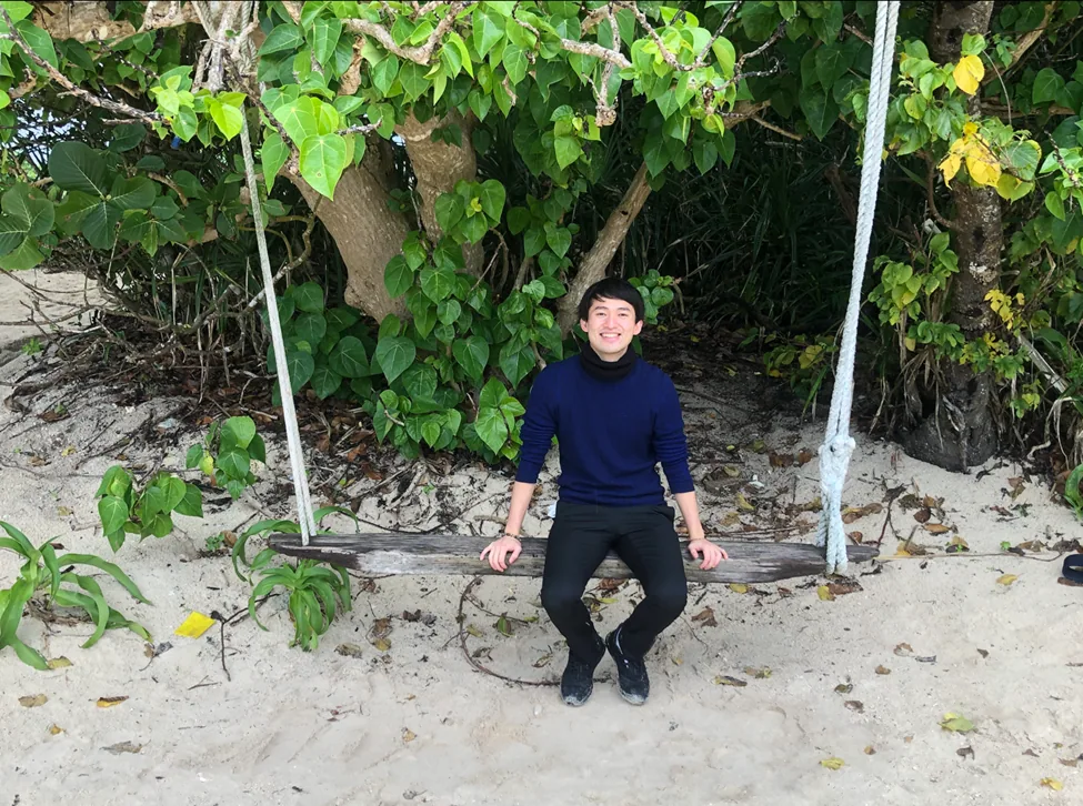 IPPONGI representative seated outdoors beneath a tree